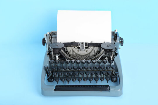 Vintage typewriter on blue background