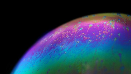 Wall Mural - macro shot of a colorful soap bubble on the black background
