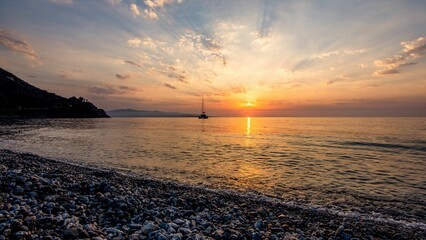 Canvas Print - Beautiful view of the beach by the golden sea in Sicily, Italy at sunset