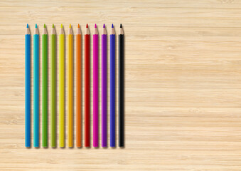 Wall Mural - Colored pencil group isolated on wooden background. Horizontal background