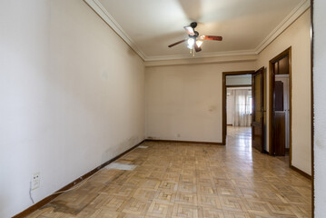 Wall Mural - An empty room with a damaged oak parquet floor