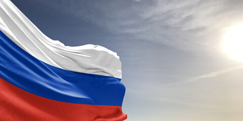 Russia national flag cloth fabric waving on beautiful grey sky Background.