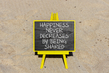 Wall Mural - Happiness symbol. Concept words Happiness never decreases by being shared on beautiful black chalkboard. Beautiful sea sand beach background. Motivational Happiness concept. Copy space.