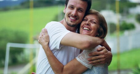 Poster - Happy, love and man hugging his mother outdoor in a park while on a family vacation together. Happiness, smile and portrait of male person embracing his mature mom in retirement with care in a garden