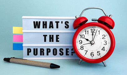 Poster - text what is the purpose written on the lightbox with alarm clock and colorfull stickers on blue bac