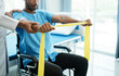 © Parichat - Asian male physical therapist working with patient doing stretching exercise with a flexible exercise band.