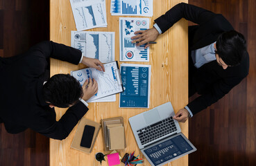 Poster - Top view analyst team discussing financial data on digital dashboard, analyzing chart and graph papers by data science software on wooden table background. Business intelligence and Fintech. Fervent