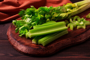 fresh bunch of celery, top view, no people, on a dark background,