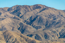 The Valley Of Palm Springs Landscape In Fall On A Hazy, Warm Afternoon From Aerial, Above Shot, Blue Sky Background In The California Desert. 