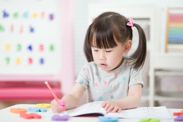 Wall Mural - young girl practice drawing different shapes  for homeschooling