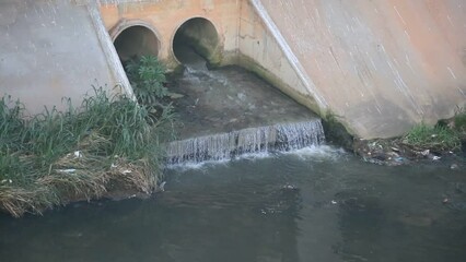 Wall Mural - salvador, bahia, brazil - may 17, 2023: pipe gushing sewage water into a stream in the city of Salvador.