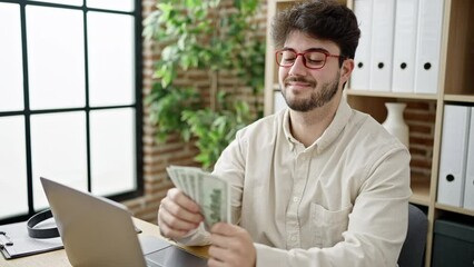 Poster - Young hispanic man business worker using laptop throwing dollars at office