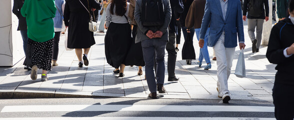 Sticker - crowd of people crossing a city street at the zebra crossing