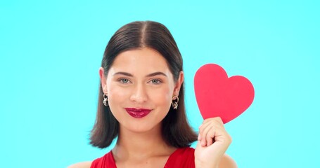 Canvas Print - Happy, heart paper and face of a woman with a smile isolated on a blue background in a studio. Love, romance and portrait of a smiling girl holding a card for valentines day and romantic gesture