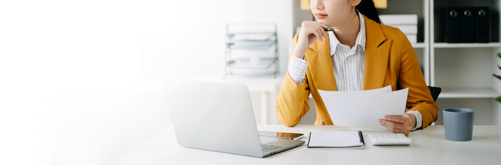 Businesswoman hand using smart phone laptop and tablet with social network diagram on desk as concept