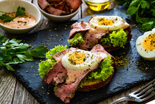 Delicious Sandwiches With Grilled Beef Sirloin Hard Boiled Eggs And Lettuce On Wooden Table
