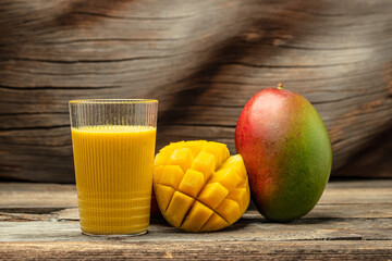 Healthy mango smoothie in a glass. Indian healthy ayurvedic cold drink with mango, Delicious breakfast or snack, vertical image. place for text