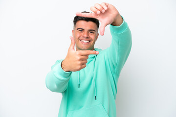 Poster - Young caucasian handsome man isolated on white background focusing face. Framing symbol