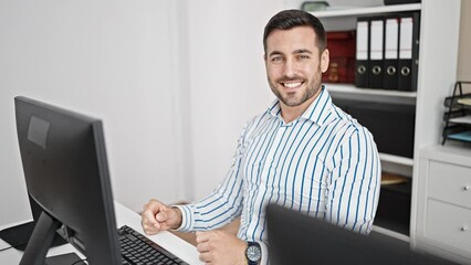 Wall Mural - Young hispanic man business worker smiling confident looking watch at office