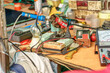 The cluttered workbench of an electronics repairman.
