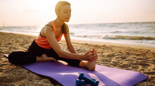 A Sporty Woman Does Exercises In The Open Air. Healthy Lifestyle, Sports Activities In The Morning In The Beach.