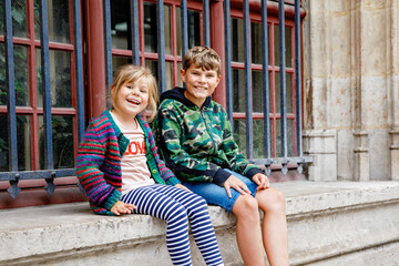 Wall Mural - Two happy siblings, little girl and school boy together. Smiling brother and sister, best friends. Family in love.