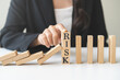 © KMPZZZ - Protection finance, stopping falling block effect collapse domino wooden, Recovery risk business, Management strategy and planning before destroy. Successful intervention.