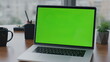 © stockbusters - Modern green screen laptop standing on office desk close up. Chroma key computer
