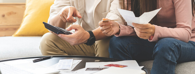 Wall Mural - Stressed financial owe asian young couple love sitting suffer, stressed and confused by calculate expense from credit card bill, no money to pay, mortgage or loan. Debt, bankrupt or bankruptcy people.