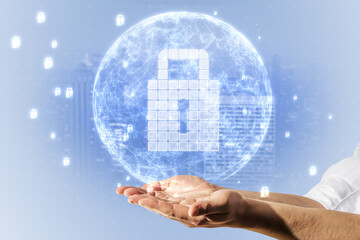 Poster - Close up of man hand using glowing globe with white safety padlock on light background. Global digital security and protection concept.