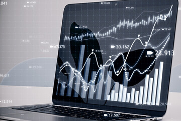 Aufkleber - Close up of laptop computer at workplace with creative candlestick forex chart or graph on blurry background. Financial trade market and stock concept. 3D Rendering.