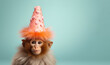 Cute fluffy monkey with a orange birthday hat against pastel background. Generative AI.
