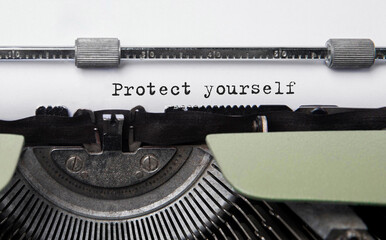 Fototapete - Text protect yourself typed on retro typewriter