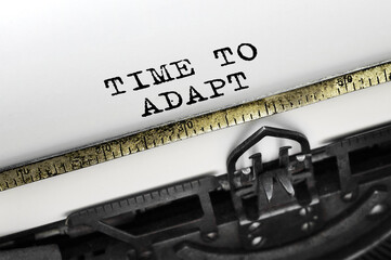 Poster - text time to adapt typed on retro typewriter