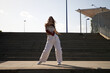 © @skuder_photographer - Latin woman, young and beautiful dancing modern dance in the street and makes different expressions and postures. Concept dance, hip hop, dance, art, action, beauty, youth art.