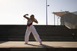 © @skuder_photographer - Latin woman, young and beautiful dancing modern dance in the street and makes different expressions and postures. Concept dance, hip hop, dance, art, action, beauty, youth art.
