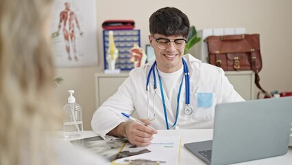 Sticker - Young hispanic man doctor having medical consultation at clinic