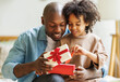 © JenkoAtaman - Happy Fathers day. African american kid son giving  gift box to dad for holiday at home