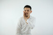 © IgnatiusHarly - Young Adult Asian man whispering something with suspicious expression, or gossipping something