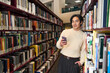 © Maria Vitkovska - Portrait of smart Japanese university student holding mobile phone in bookstore