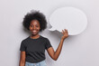 © wayhome.studio  - Smiling Afro woman dressed in casual clothes holds blank speech bubble showcases essence of peoples ideas and power of contemplation isolated over white background. Place your information here