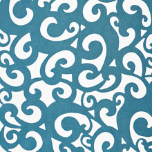 Blue Scrapbook Die-cut Paper, Featuring Swirls Or Stylized Paisley Cutout Designs On A White Surface
