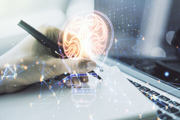 Poster - Double exposure of creative light bulb hologram with human brain and with hand writing in notebook on background with laptop, idea and brainstorming concept