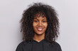 © wayhome.studio  - Portrait of happy curly haired teenage girl smiles pleasantly looks directly at camera dressed in casual black sweatshirt isolated over white background beams with joy has genuine smile on face