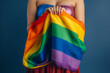 © Natural Sources - Expressive Generative AI pride photo of a lesbian woman with rainbow flag patterns. Inclusive society with equal rights. Pride day month celebration of diversity and inclusion.