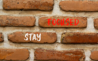 Stay focused symbol. Concept words Stay focused on beautiful brown brick wall on a beautiful brown brick wall background. Business, support, motivation, psychological stay focused concept. Copy space.