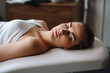 © alexkoral - young woman on couch in spa salon for massage and beauty treatments. Generative AI