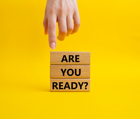 Are you ready symbol. Concept word Are you ready on wooden blocks. Businessman hand. Beautiful yellow background. Business and Are you ready concept. Copy space