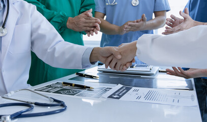 Professional doctors meeting in conference room at modern hospital, Healthcare and medical concept, Team of doctors handshake,