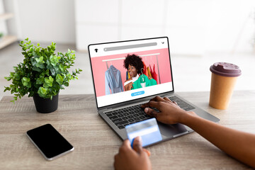 Poster - Millennial black lady with credit card, laptop and smartphone buying online on website or app